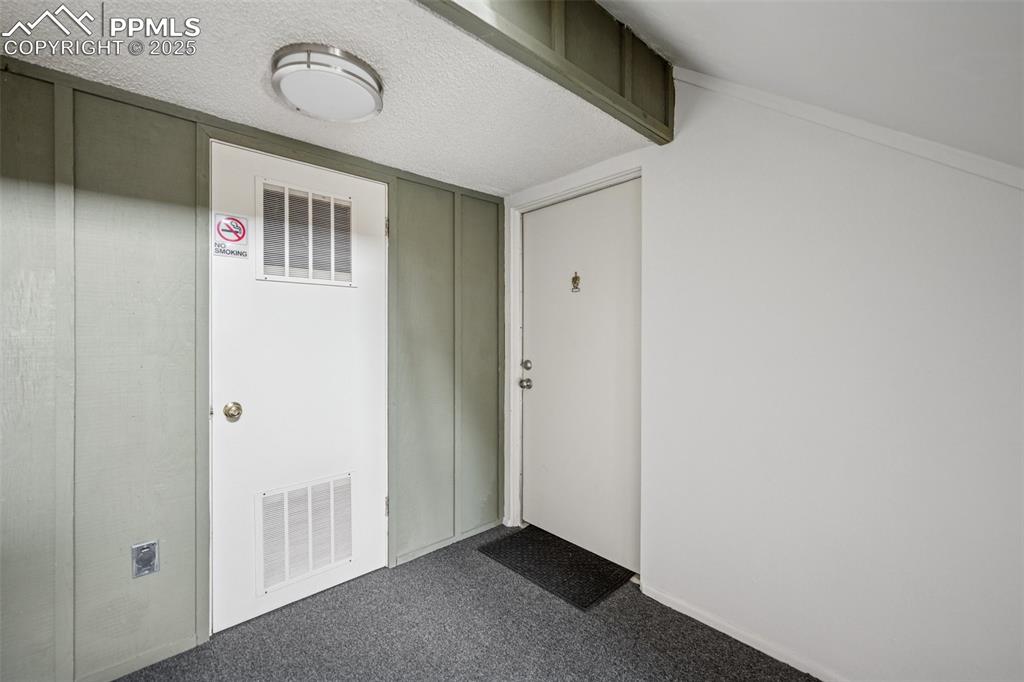 Image 2 of 11: Secure shared entry with indoor hallway access to the unit.