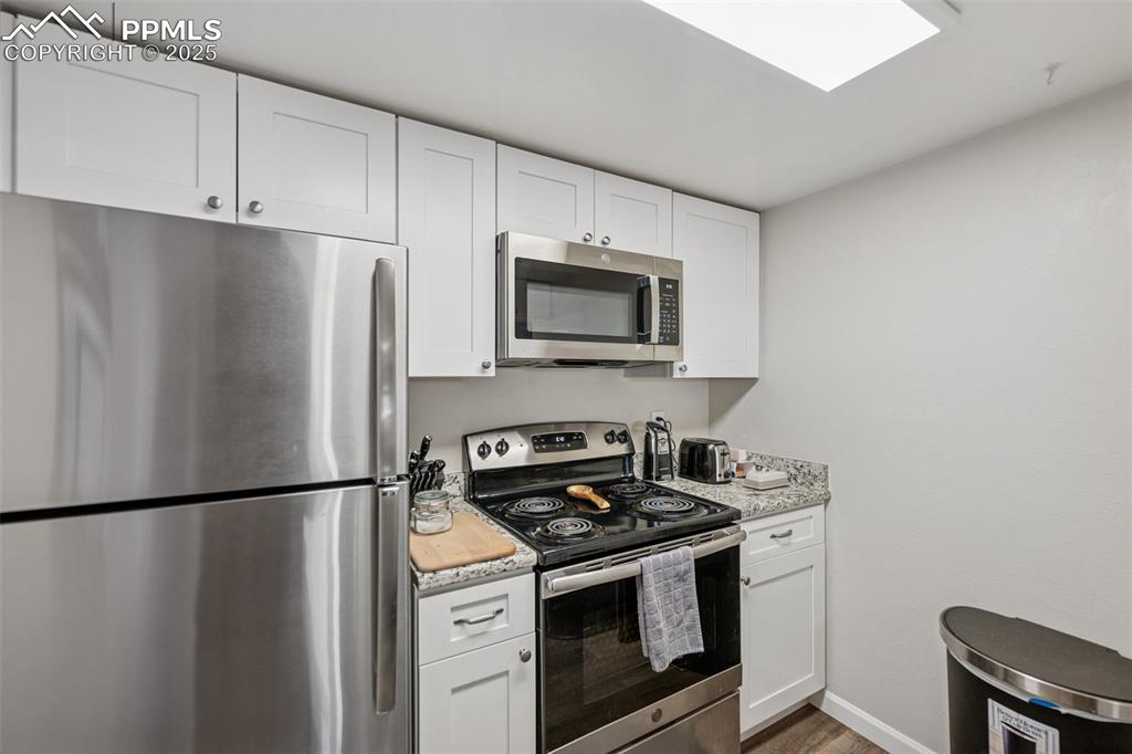 Image 5 of 11: Updated kitchen with stainless steel appliances and granite counters.