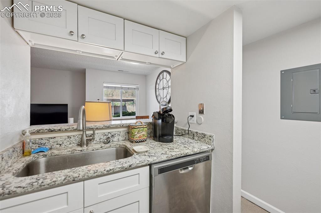 Image 6 of 11: Kitchen passthrough overlooks the living area, creating an open flow.