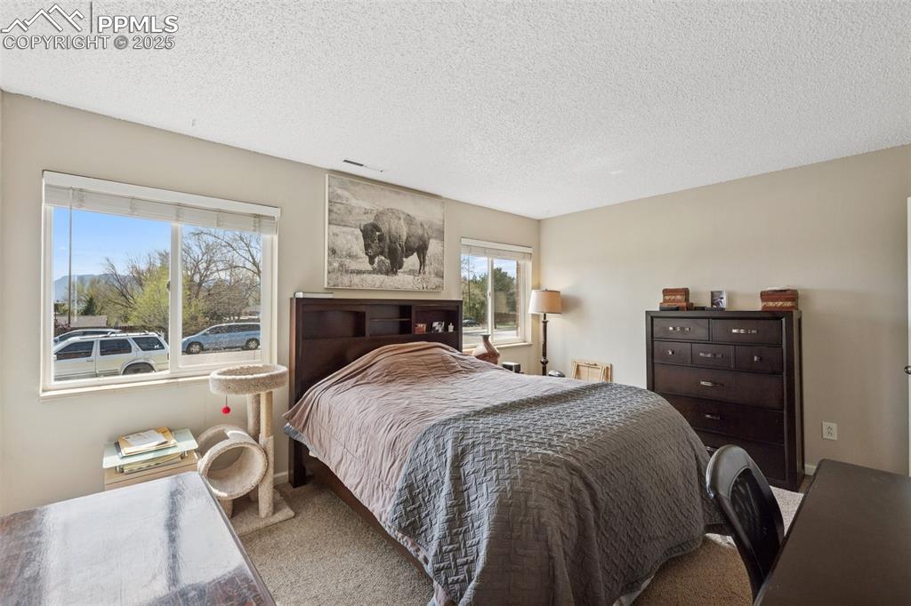 Image 7 of 11: Large bedroom with dual windows and plenty of natural light.
