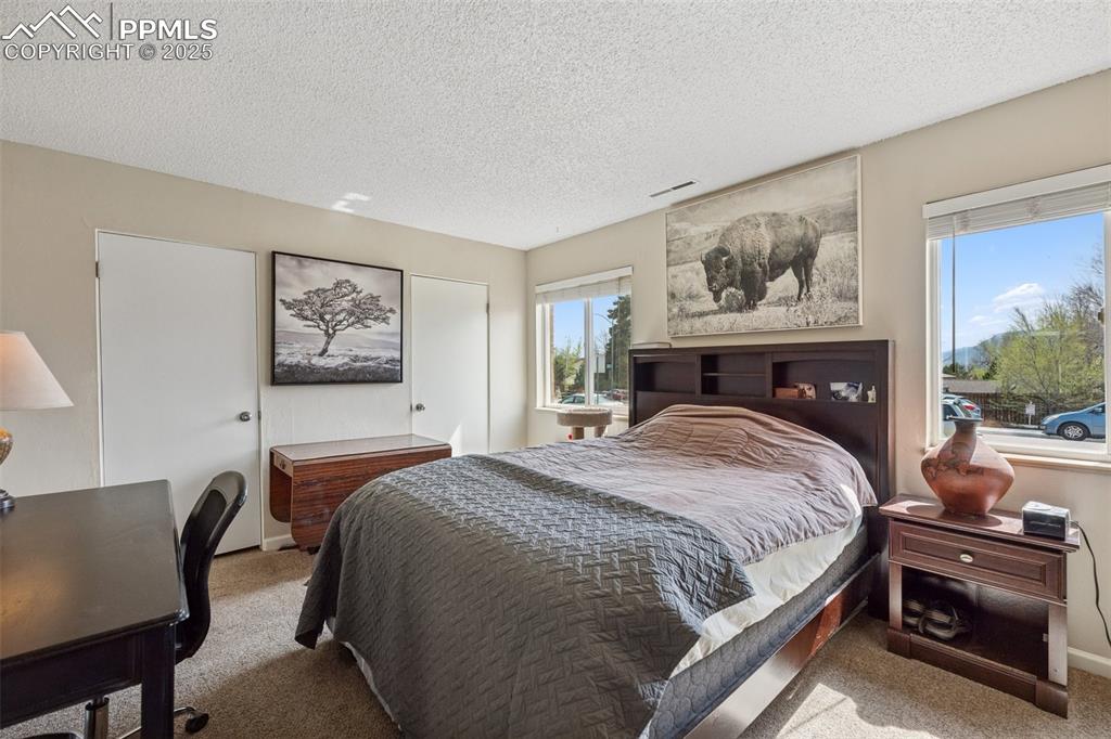 Image 8 of 11: Comfortable layout with space for a desk or reading area.