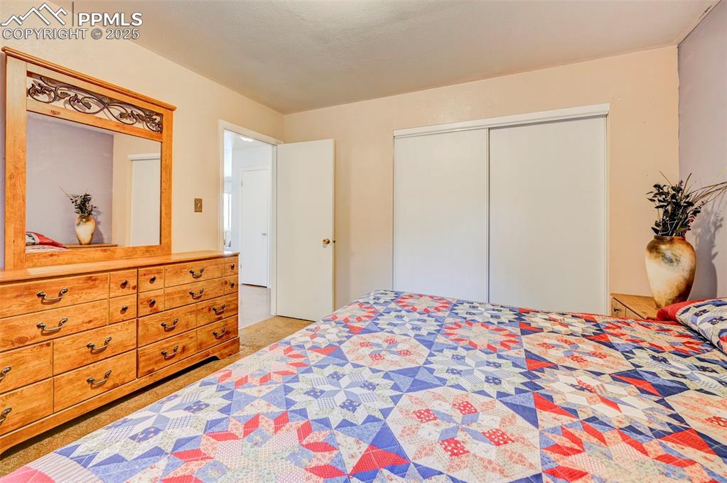Image 14 of 30: Bedroom with carpet and a closet