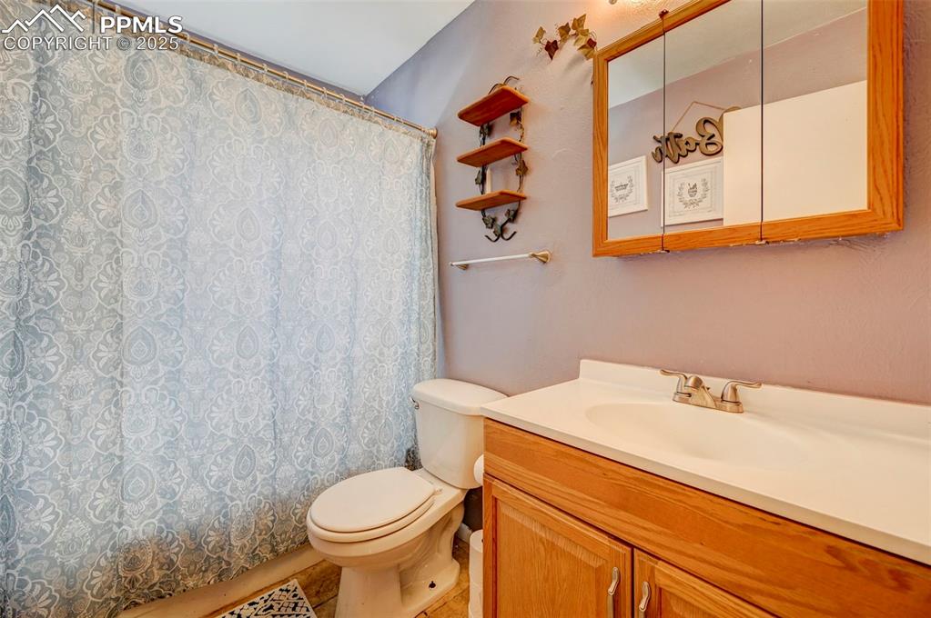 Image 22 of 30: Bathroom featuring vanity and curtained shower