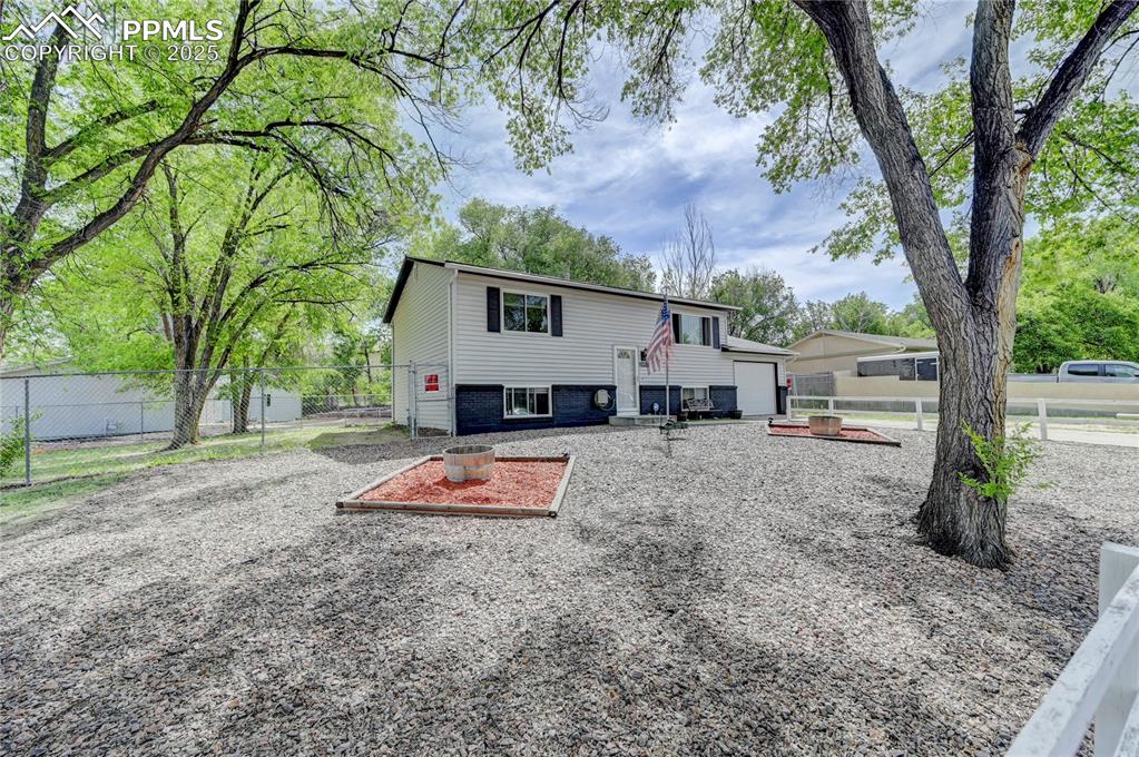 Image 3 of 30: View of front of property with a garage