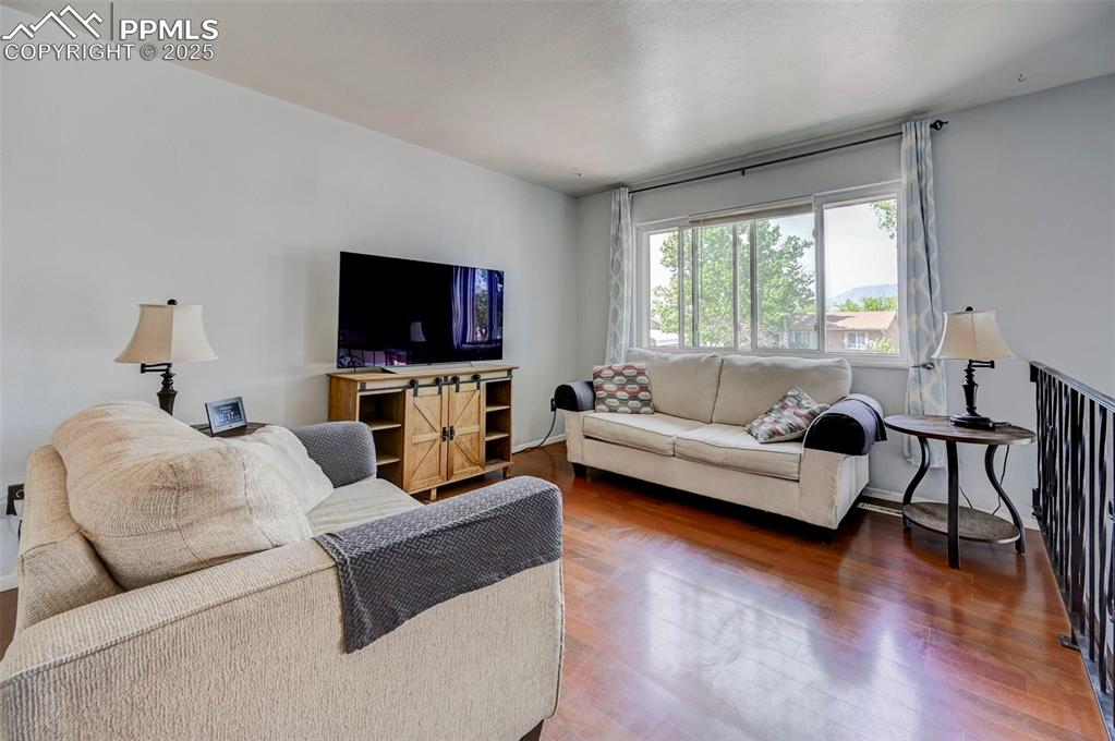 Image 5 of 30: Living room featuring wood finished floors