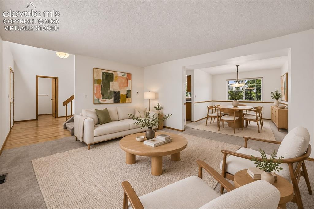 Image 6 of 45: Virtually staged living & Dining area off entryway