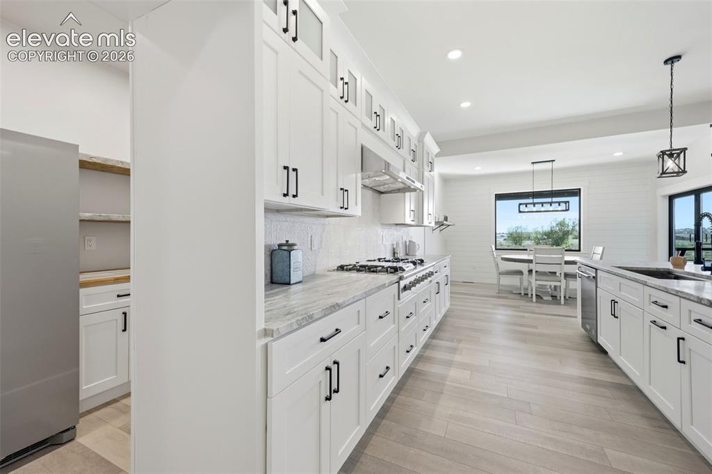 Image 12 of 50: Kitchen with hidden pantry access