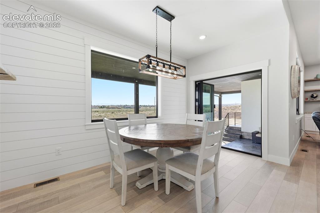Image 16 of 50: Dining room with access to back patio for entertaining