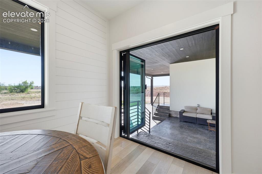 Image 17 of 50: Dining area wide open glass door for access to patio for entertaining