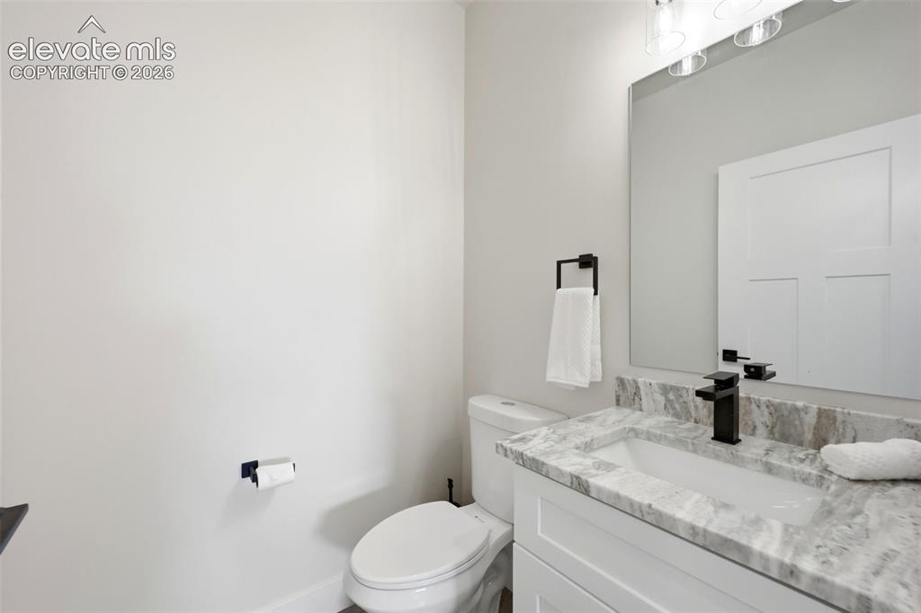 Image 33 of 50: 1/2 bath near drop zone and garage enterance