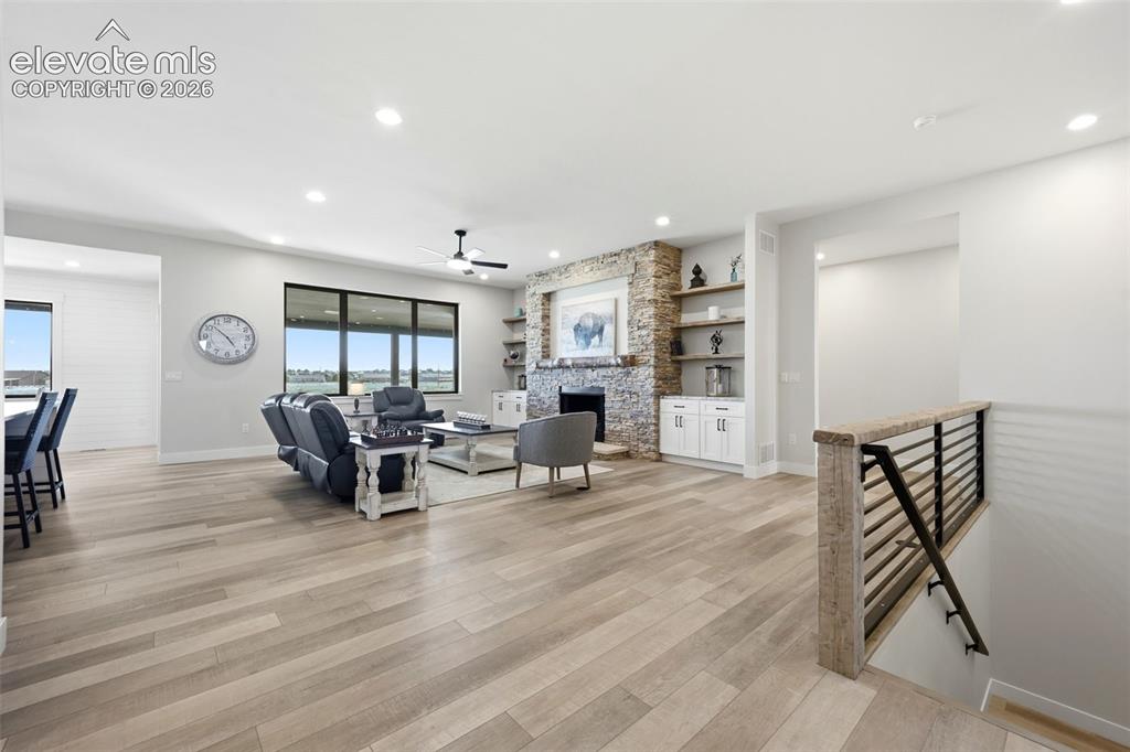 Image 4 of 50: Great room, living room with staircase to lower living quarters.