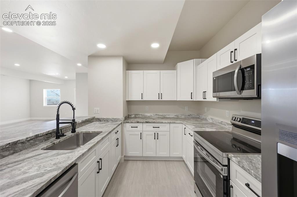 Image 42 of 50: Wet bar and full kitchen in basement