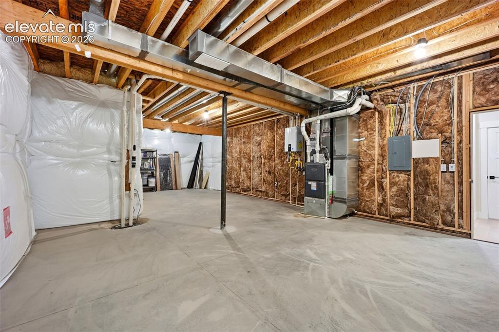 Image 49 of 50: Unfinished storage area and utility room
