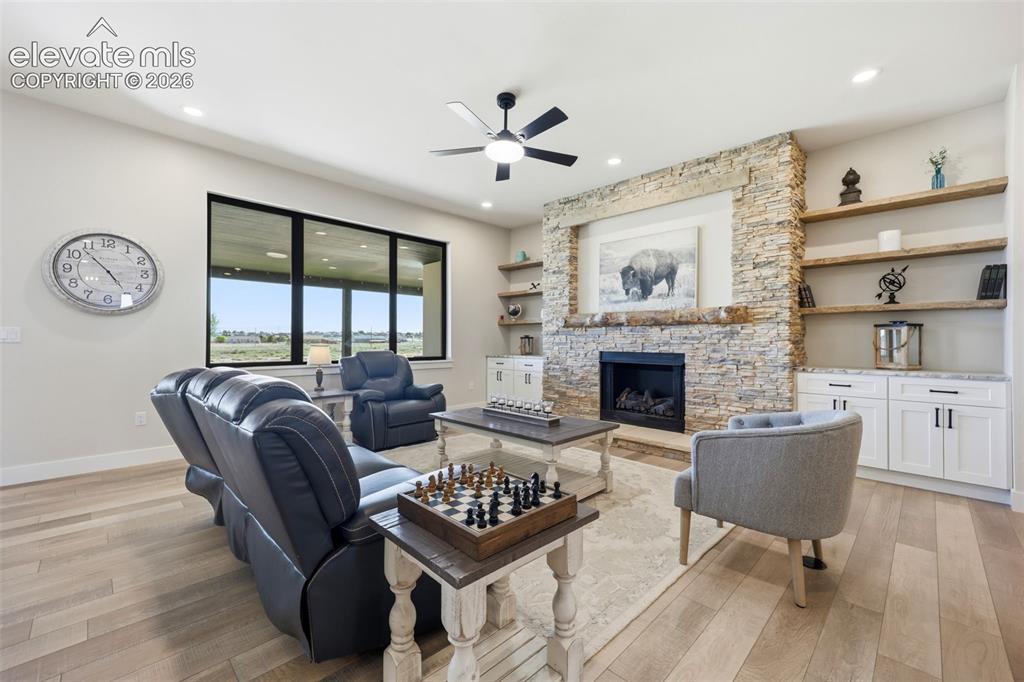 Image 5 of 50: Living room with fireplace and built ins.