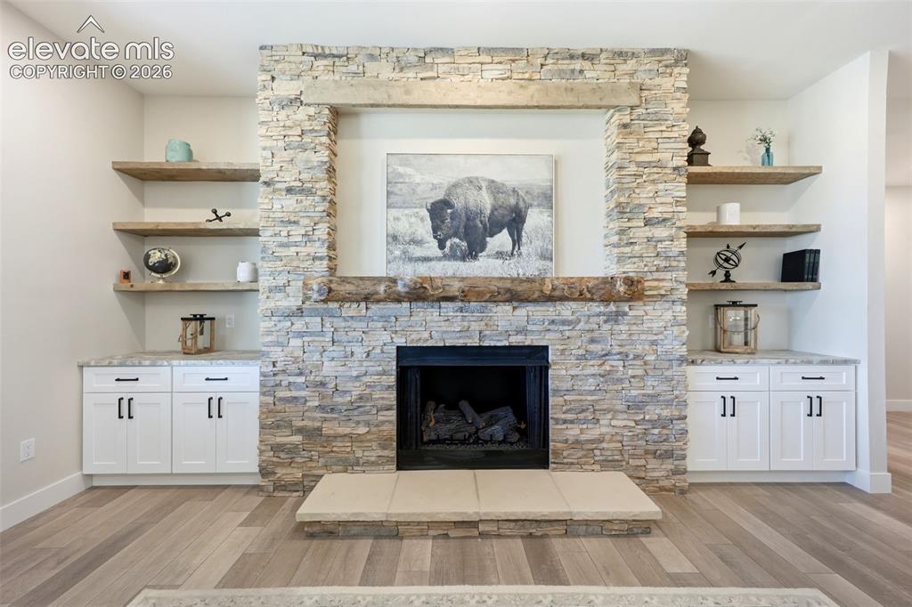 Image 6 of 50: Rock fireplace with built-in shelves.
