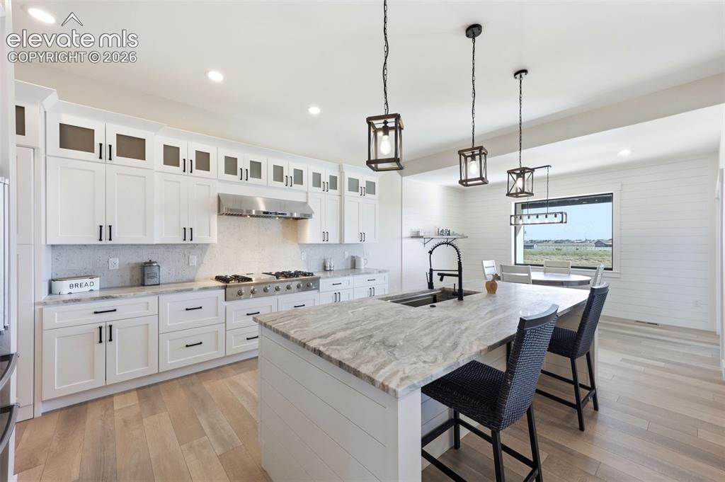 Image 8 of 50: Sit at island in the kitchen main floor
