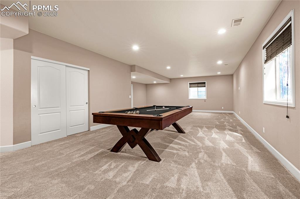 Image 23 of 37: Recreation room featuring light carpet, pool table, and recessed lighting