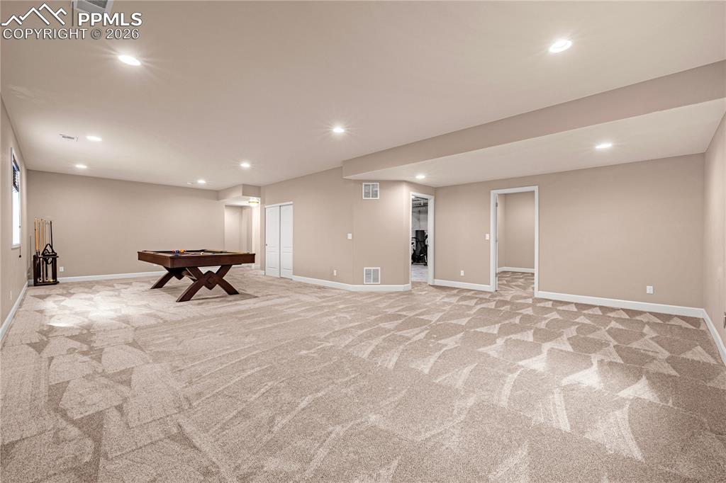 Image 24 of 37: Finished basement featuring recessed lighting, pool table, and light carpet