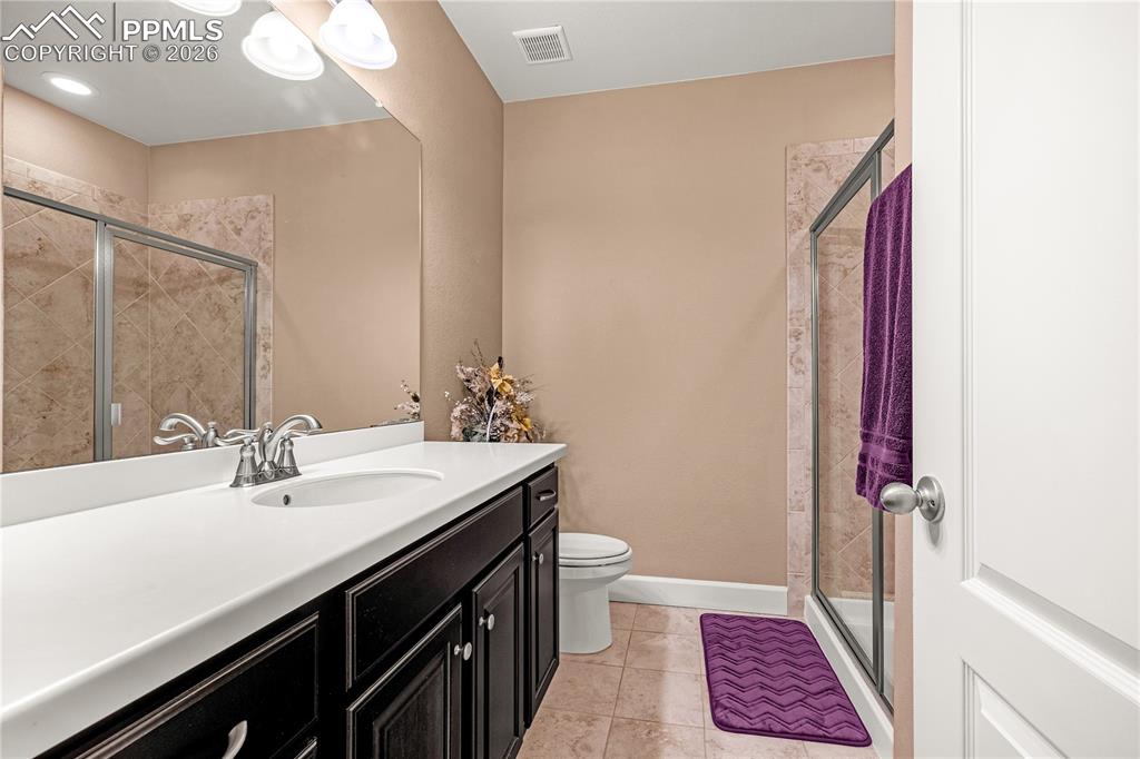Image 30 of 37: Full bath featuring a stall shower, vanity, and light tile patterned floors
