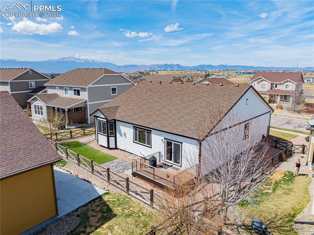Image 33 of 37: Rear view of property featuring a shingled roof, a residential view, a deck