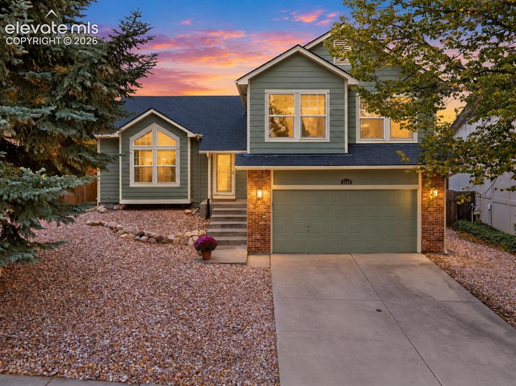 Image 1 of 37: Two-story residence featuring siding and brick accents, an attached garage,