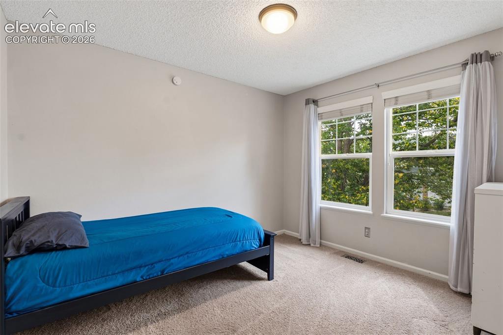 Image 21 of 37: Light-toned walls, recessed lighting, and dual windows with white trim