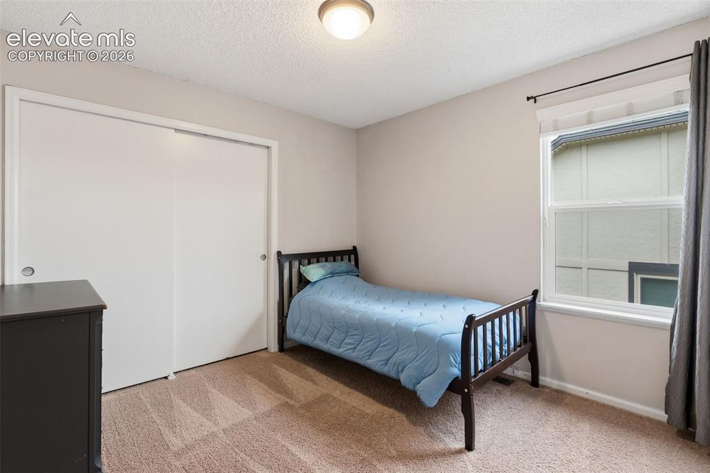 Image 22 of 37: Carpeted flooring with a white sliding door closet, recessed window, and fl