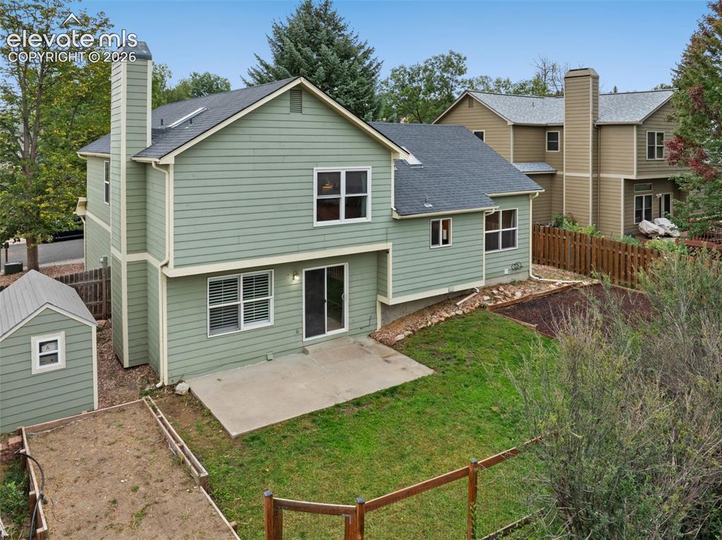 Image 31 of 37: Siding exterior with multiple windows, a concrete patio, and a storage shed