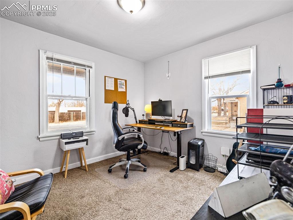 Image 18 of 33: Office with light carpet and baseboards