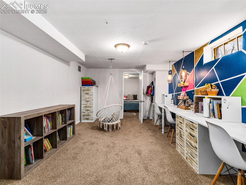 Image 21 of 33: Office area featuring light colored carpet