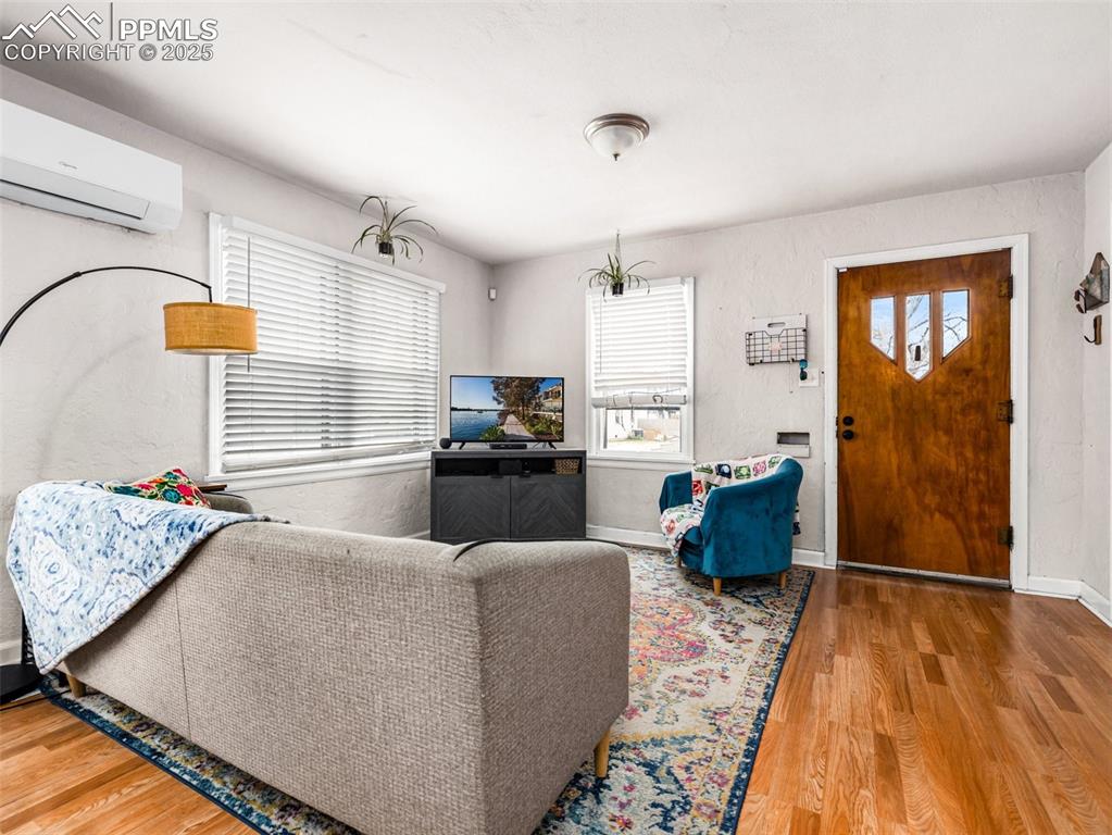 Image 8 of 33: Living room with light wood finished floors, plenty of natural light, and a