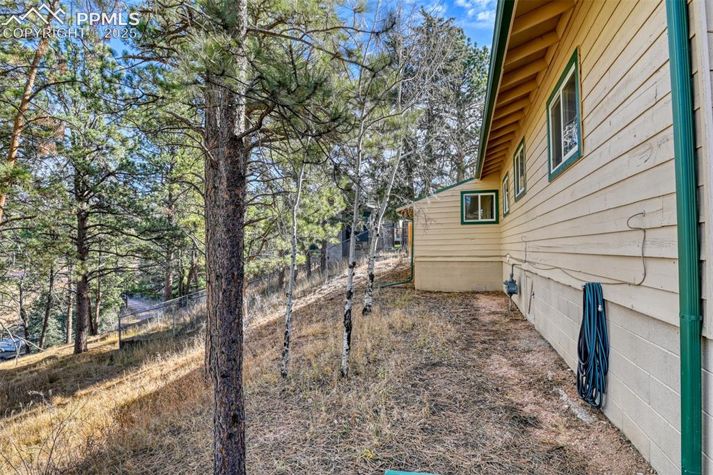 Image 15 of 43: View of yard featuring view of wooded area
