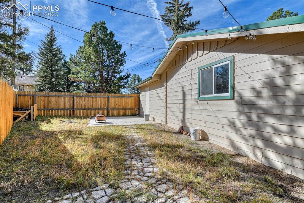 Image 17 of 43: Fenced backyard featuring a patio area and an outdoor fire pit