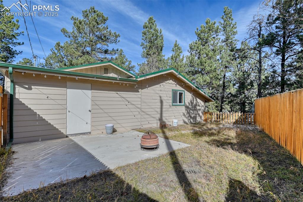 Image 18 of 43: Rear view of house featuring a fenced backyard and a patio area