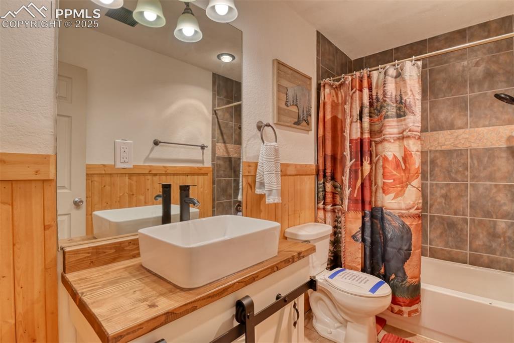 Image 30 of 43: Full bath featuring shower / bathtub combination with curtain, vanity, and