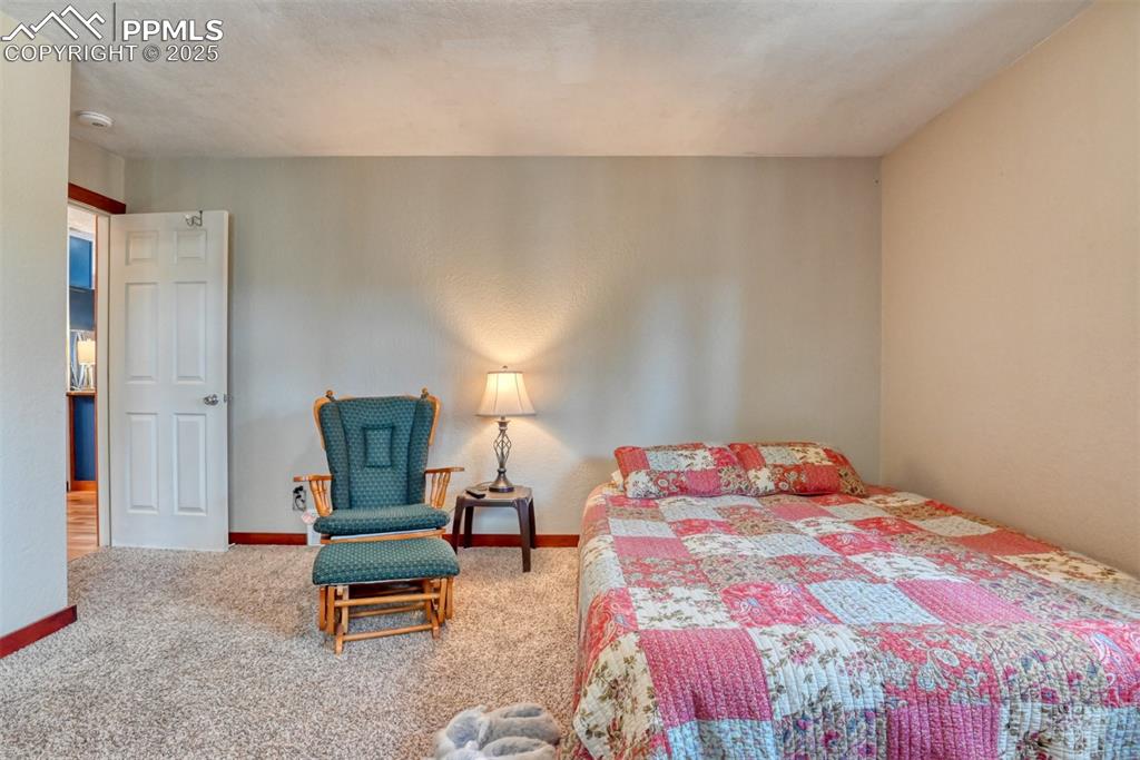 Image 32 of 42: Carpeted bedroom with baseboards