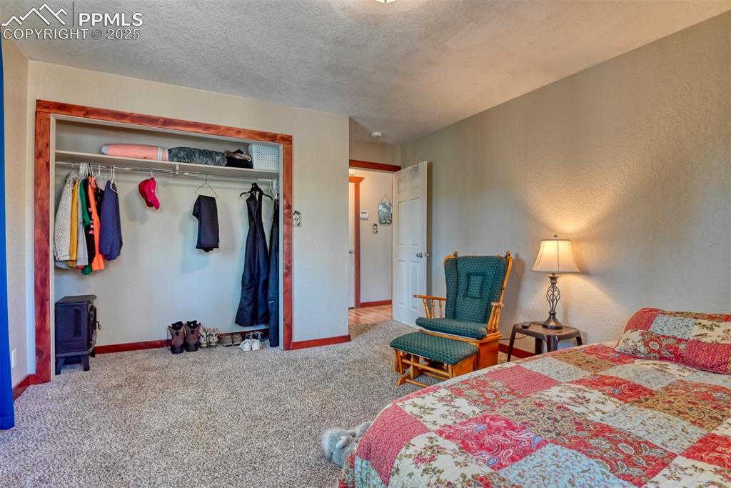 Image 32 of 43: Carpeted bedroom featuring a closet and a textured ceiling