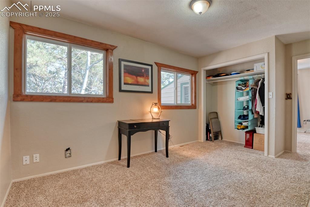 Image 34 of 43: Carpeted bedroom featuring a closet and a textured ceiling