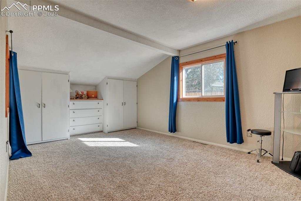 Image 38 of 43: Additional living space featuring carpet and a textured ceiling