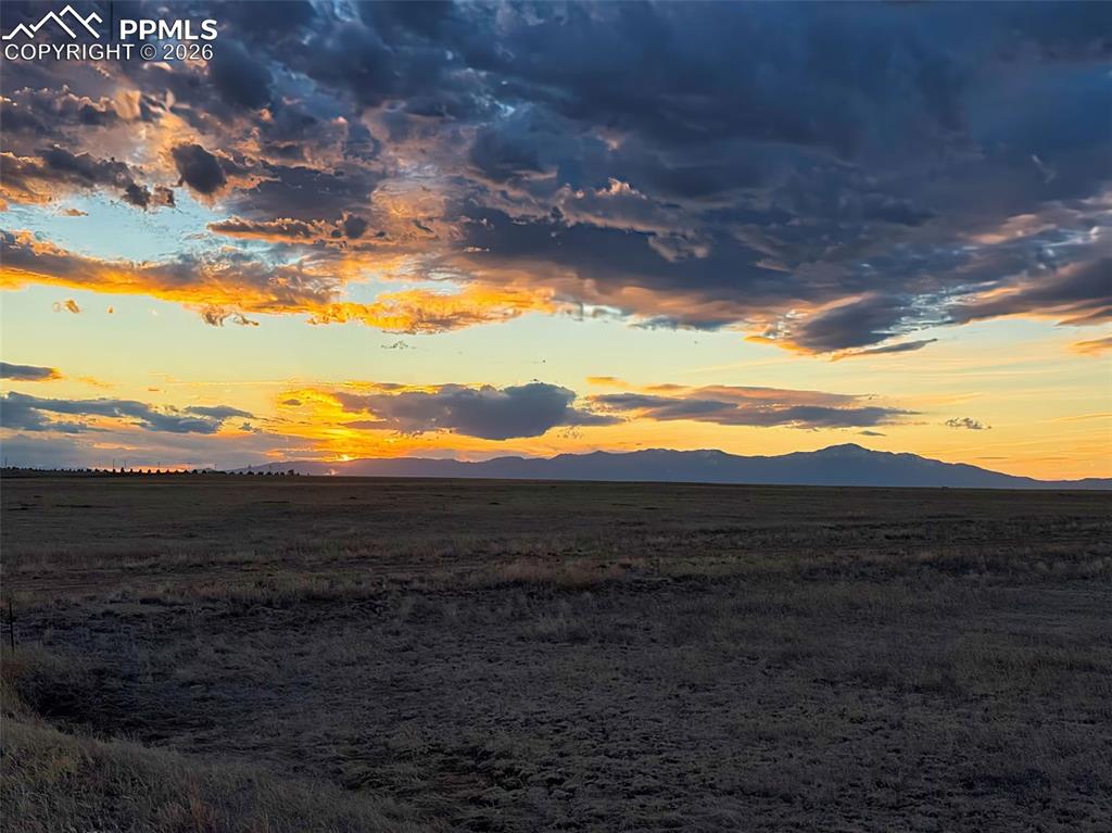 Image 8 of 12: Sunset View – Mountain Backdrop – Vibrant evening colors highlight the moun
