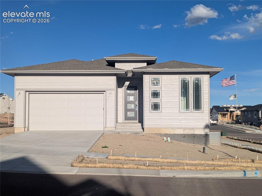 Image 1 of 45: Contemporary single-story residence featuring light gray siding and a dark