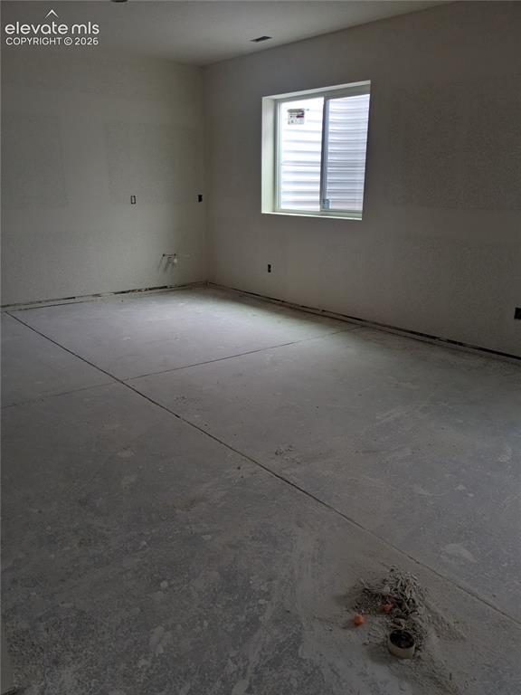 Image 29 of 45: Unfinished interior space featuring a single window and concrete flooring