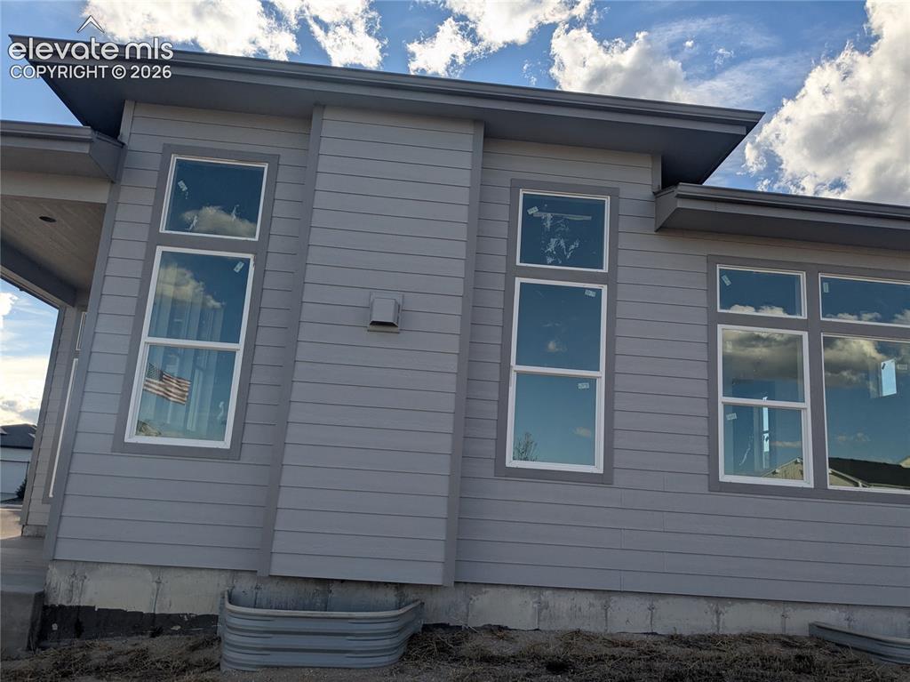 Image 44 of 45: Contemporary exterior with gray horizontal siding and contrasting white win