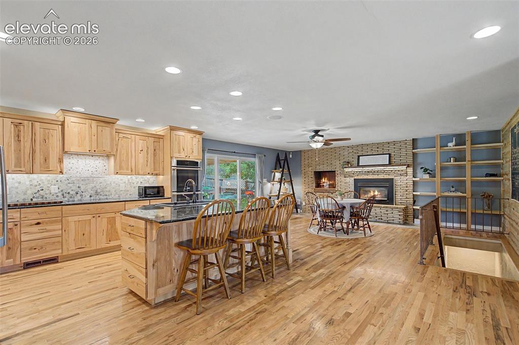 Image 8 of 34: Hickory cabinets and hardwood floors