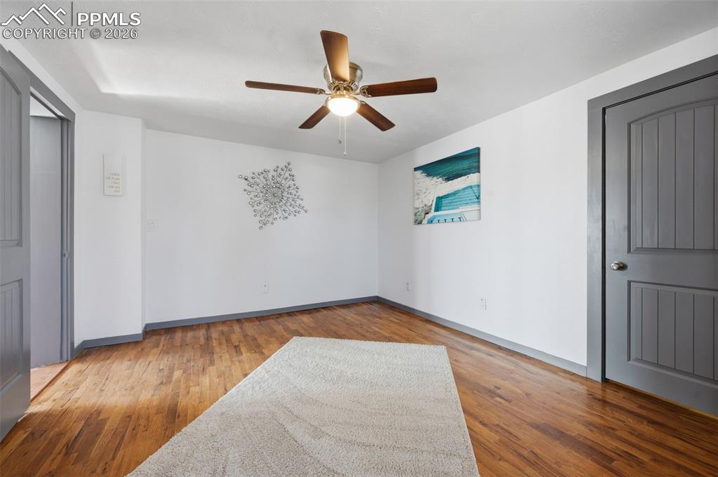 Image 21 of 50: The original hardwood flooring is still beautiful and funcitonal in this ro