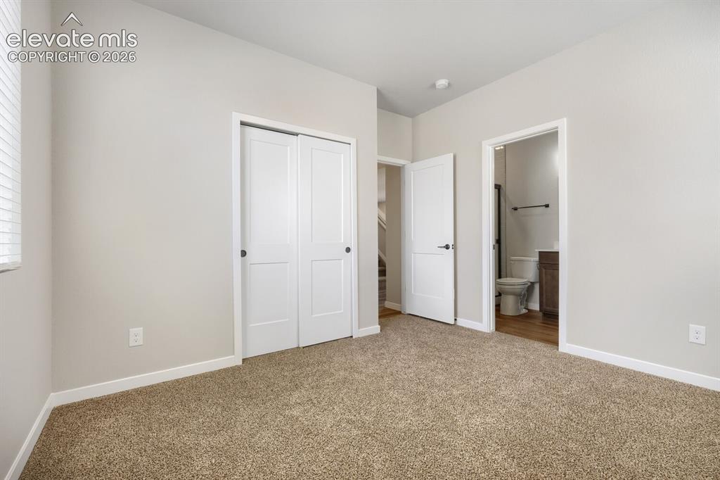 Image 11 of 31: Bedroom 5 with attached bathroom on main floor