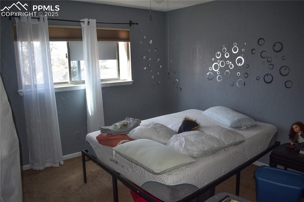 Image 10 of 24: Bedroom featuring baseboards and carpet