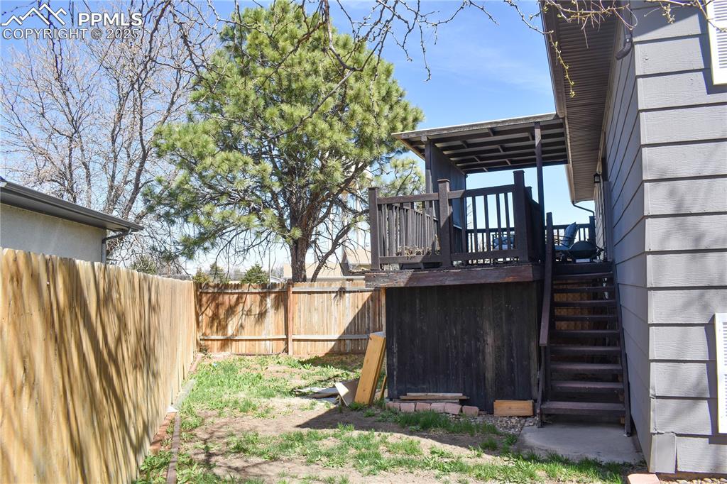 Image 16 of 24: View of yard featuring a fenced backyard and a wooden deck