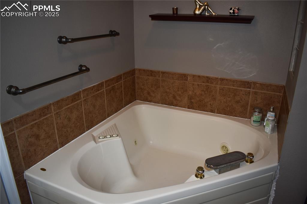 Image 9 of 24: Full bath with a whirlpool tub