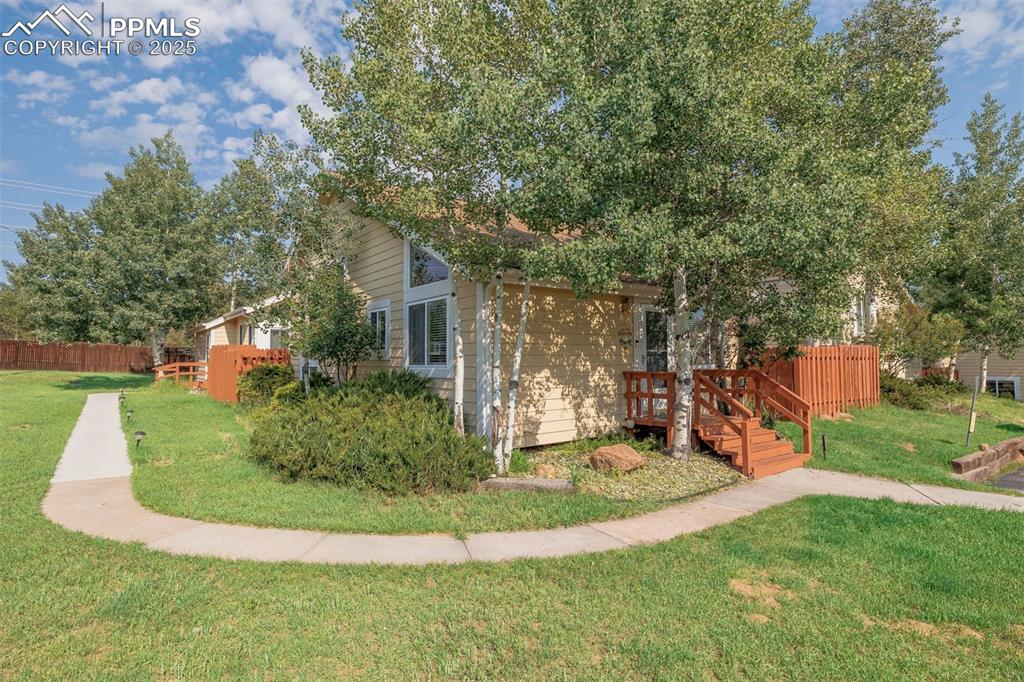 Image 1 of 15: View of side of property with a wooden deck